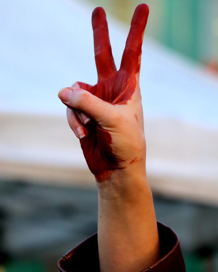 A painted hand making a peace sign, symbolizing harmony and hope.